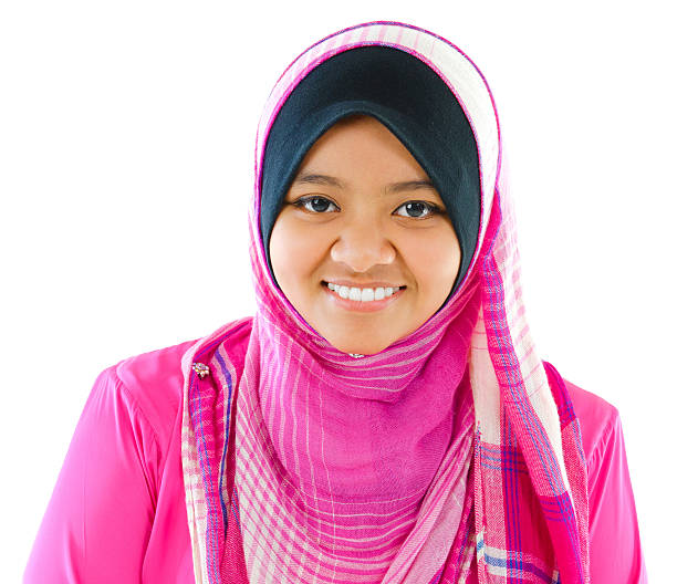 Young Muslim girl smiling on white background