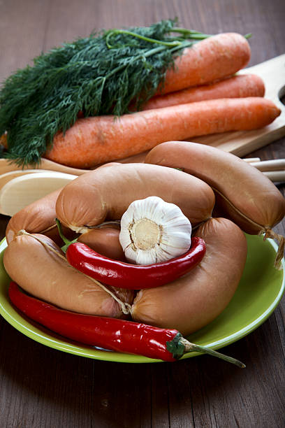 istock Sausages with spices and vegetables on an old  table 177022120