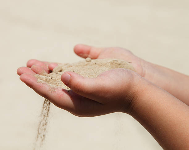 istock Hands of the child holding sand 177022516