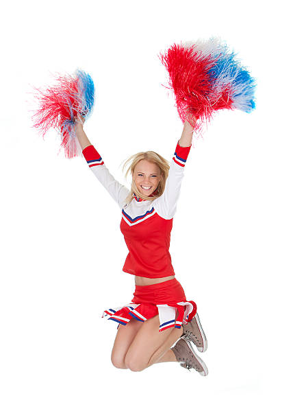 istock A smiling cheerleader jumping while holding Pom poms 177022646