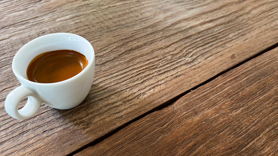 Hot espresso on a wooden table