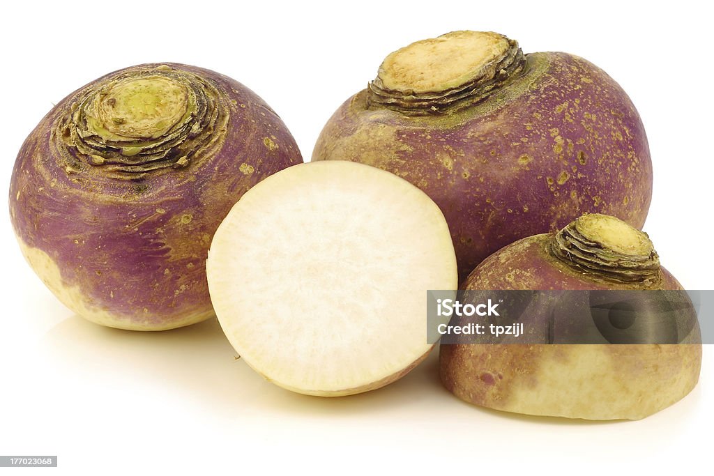 fresh turnips and a cut one fresh turnips and a cut one on a white background Rutabaga Stock Photo