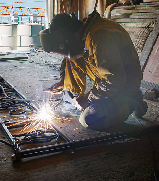 istock Welder with protective mask welding metal 177023075