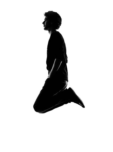 young man funny jumping silhouette in studio on white background