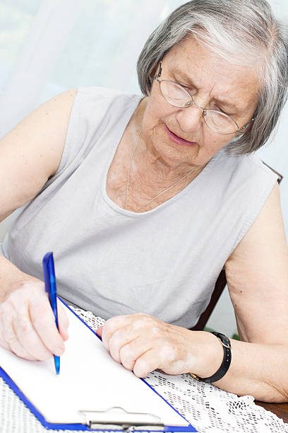 istock Senior woman Signing a Document 177024189