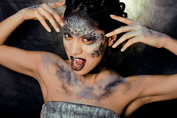 istock woman with creative make up like a snake 177024232