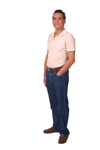 Young male standing looking down. Full body length portrait isolated over white background.