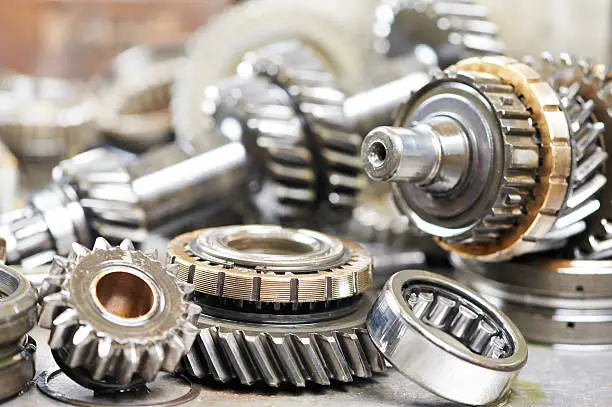 Close-up of automobile engine steel gears and bearings disassembled for repair at car service stationClick on banner below to view more images in the