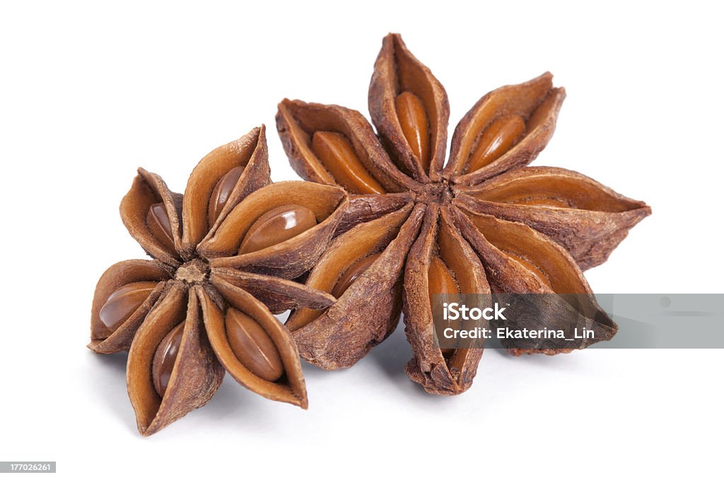 Anise star (Illicium verum) isolated on white background. "Anise star (Illicium verum) isolated on white background. Also called Star aniseed, or Chinese star anise. Used as a spice in cuisines all over the world. The plant is also used in medicine." Star Shape Stock Photo