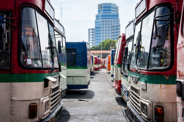 A vibrant jeepney is parked in front of a large mural showcasing traditional Filipino attire and culture in the city of Baguio in the Philippines. A street scene filled with rich colors and history.