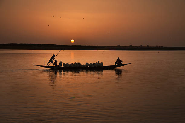 Sunset with Canoe on the Niger River "Sunset with Canoe (traditional pirogue) on the Niger River near Mopti, Mali. Africa" Mali stock pictures, royalty-free photos & images