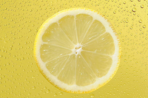 istock Lemon with many water drops on the yellow background 177027431