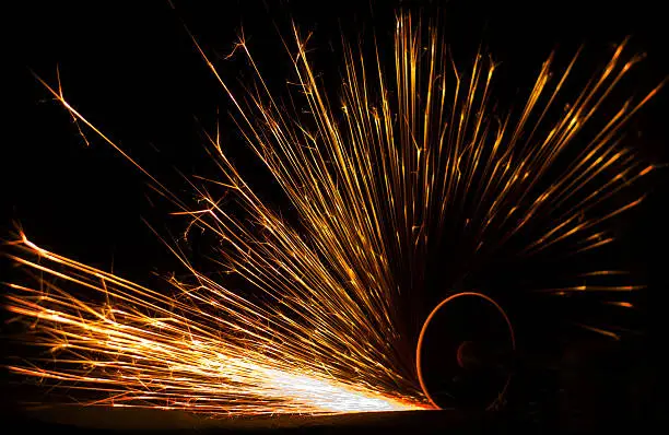 A photo of a grinding tool and resulting sparks.