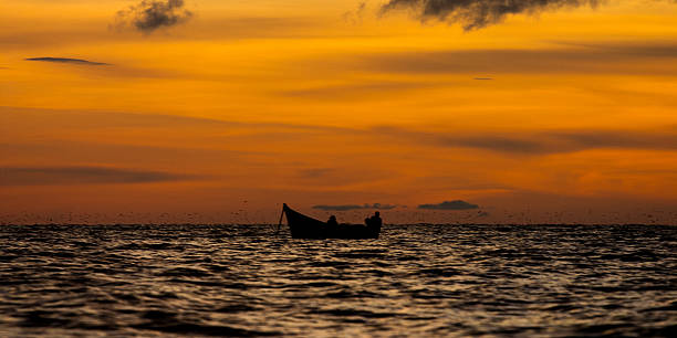 Sunset on the lake Fishermen at sunset on Lake Victoria lake victoria stock pictures, royalty-free photos & images