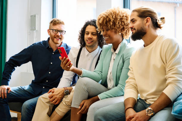 istock Multi-ethnic young people using mobile sitting on a coworking 1770276526