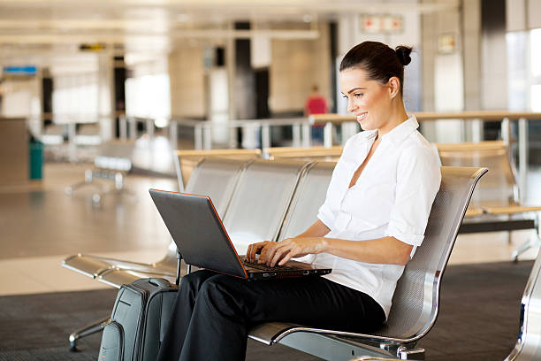 istock woman using laptop computer at airport 177027865