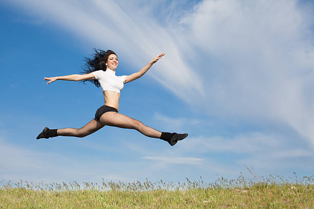 istock Brunette jumps on background of sky 177027889