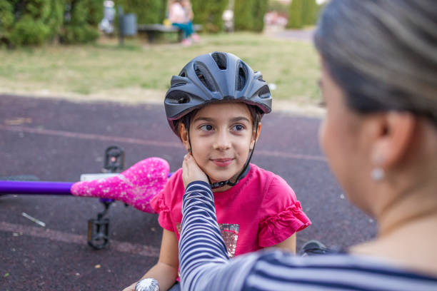 istock Mom strokes her daughter's cheek after successfully riding a bicycle 1770287720