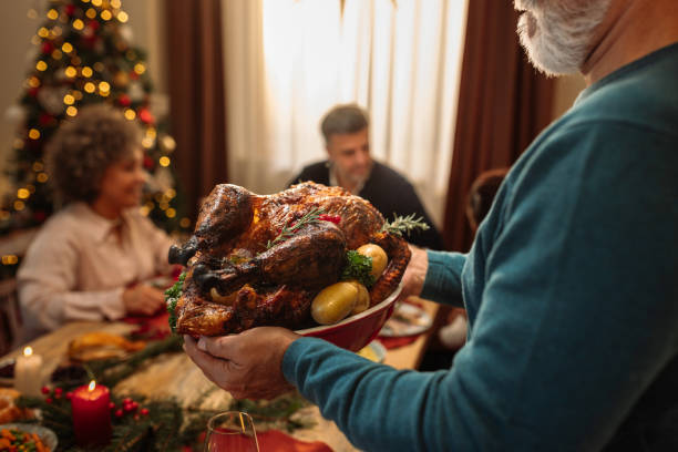 istock Roasted chicken held by grandpa during lunch 1770289420