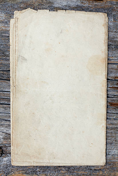 istock old dark grey paper on a wooden surface 177029278