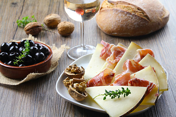 cured iberian ham and manchego cheese tapas typical spanish tapas machego stock pictures, royalty-free photos & images