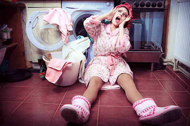 young housewife with washing machine and towels. stock photo