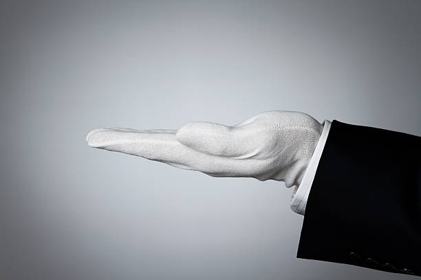 Butler's hand Side view of elegant human hand offering some product or waiting for a tip formal glove stock pictures, royalty-free photos & images