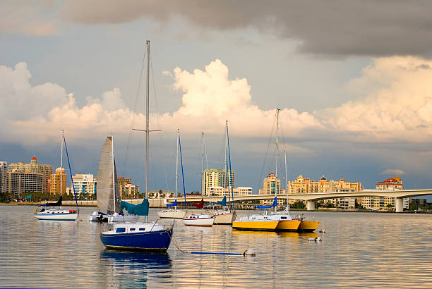 Boats anchored in a horbor under cloudy skies