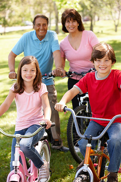 istock Hispanic family riding bikes in park 177031036