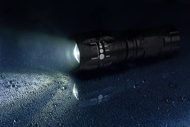 Tactical waterproof flashlight Tactical waterproof flashlight with waterdrops and smoke flashlight stock pictures, royalty-free photos & images