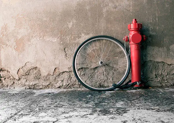 stolen wheel stays nearby a red fire hydrant