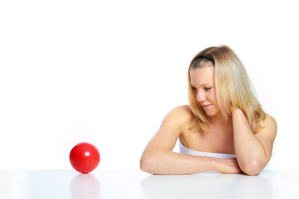 portrait of a woman on white ground with red ball stock photo