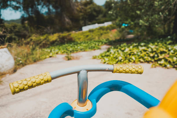 First person view of a trycicle handelbar as a nostalgic childhood image of a old generation of kids