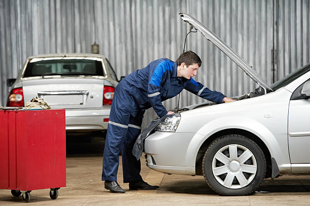 istock A car mechanic working on an open hood grey car intensely 177032165