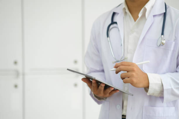 istock Close up of doctor hands using digital tablet at clinic. 1770321749