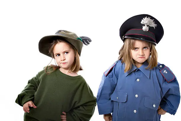 twins children in white background in carabinieri and alpini similar original uniform