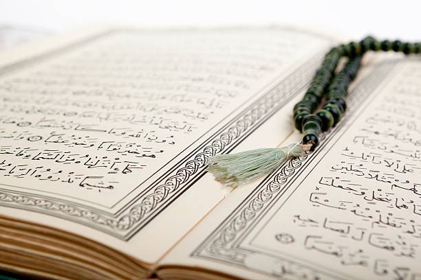 Holy Quran with prayer beads. stock photo