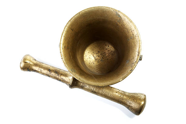 Brass mortar with a pestle isolated on white background