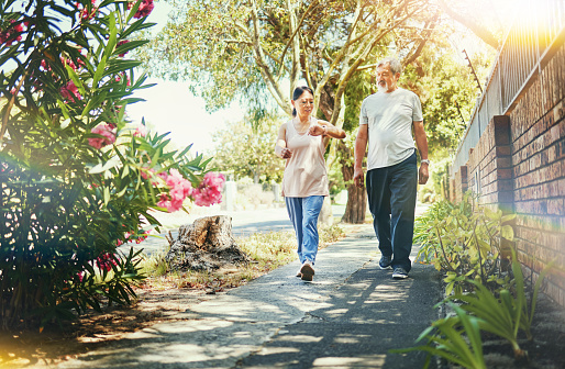 Street, neighborhood and senior couple walking as fitness , exercise and outdoor workout together as wellness. Health, time and calm elderly people on retirement training muscle or sport freedom