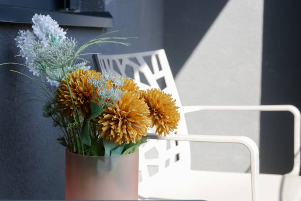 istock Nice orange flowers in vase on the balcony table, home decor concept 1770334025