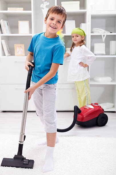 istock Kids cleaning the room - using a vacuum cleaner 177033451