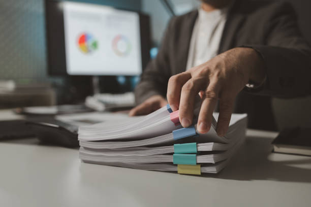 istock Preparing documents to attend the meeting, Checking documents that employees have brought in the office, Arrange printed information into relevant categories. 1770337248