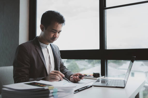 istock he is using his phone to find information to use in presenting information, Entrepreneurs use smartphones to keep in touch with business partners while working in the company, startup idea. 1770340587
