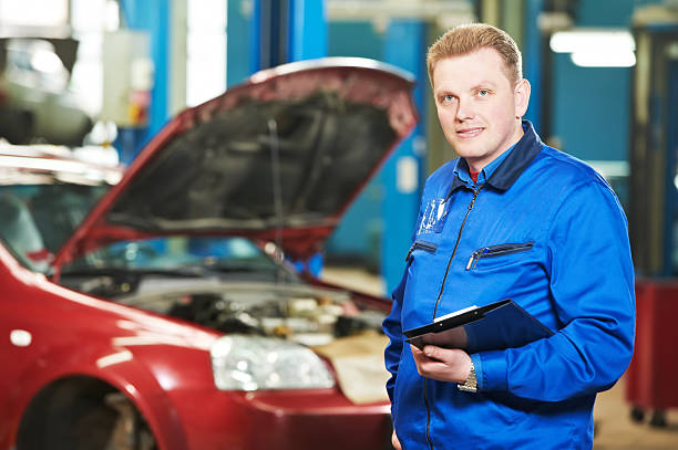 istock Man in blue jacket holding a notebook in front of a red car 177035484