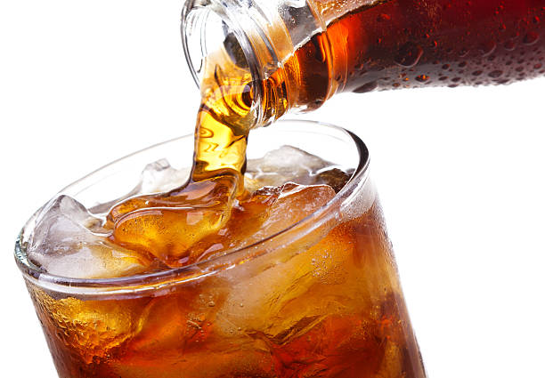 istock Cola pouring into a glass with ice 177035529