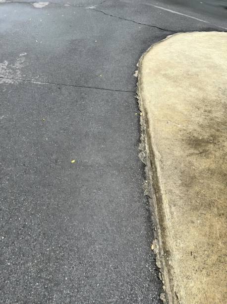 istock a concrete curb next to a street with a curb. 1770355502