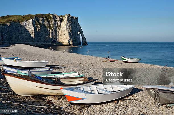 Small Boats On Pebble Beach Of Etretat In France Stock Photo - Download Image Now - Beach, Blue, Cliff