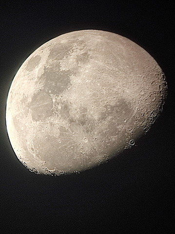 half waxing gibbous moon on night sky