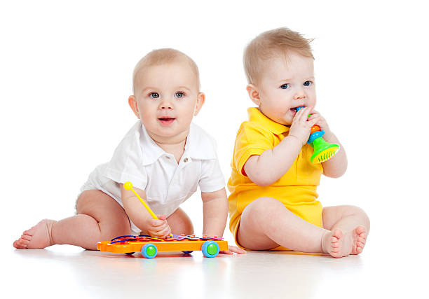 istock Funny babies  with musical toys on white background 177036158