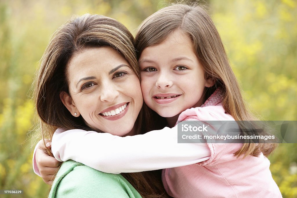 Portrait of Hispanic mother and daughter Portrait of Hispanic mother and daughter hugging outside 40-49 Years Stock Photo